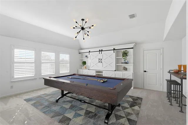 a room with pool table and windows