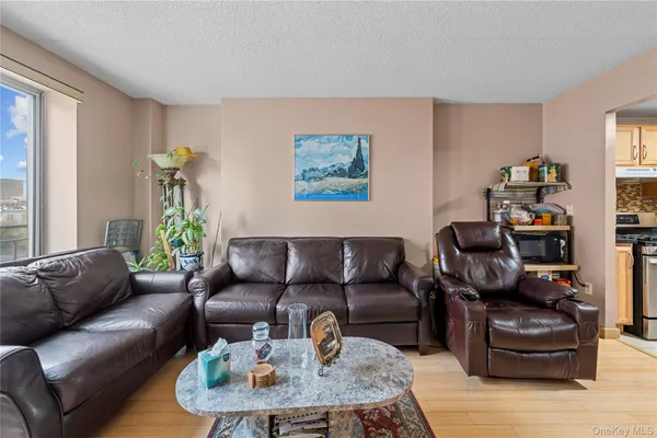 a living room with furniture a flat screen tv and a large window
