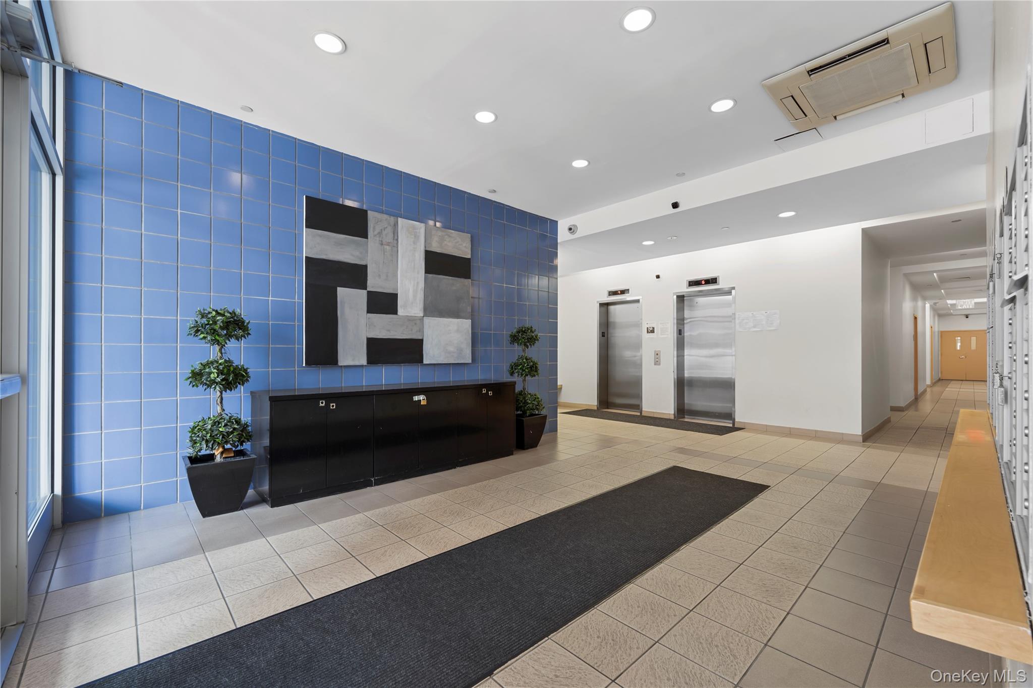 3044 3rd Avenue, Unit 6D Bronx, NY 10451 - Photo 16 of 19 a living room with a couch and a potted plant