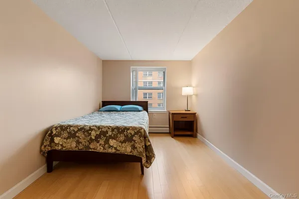 a bedroom with a bed and a night stand