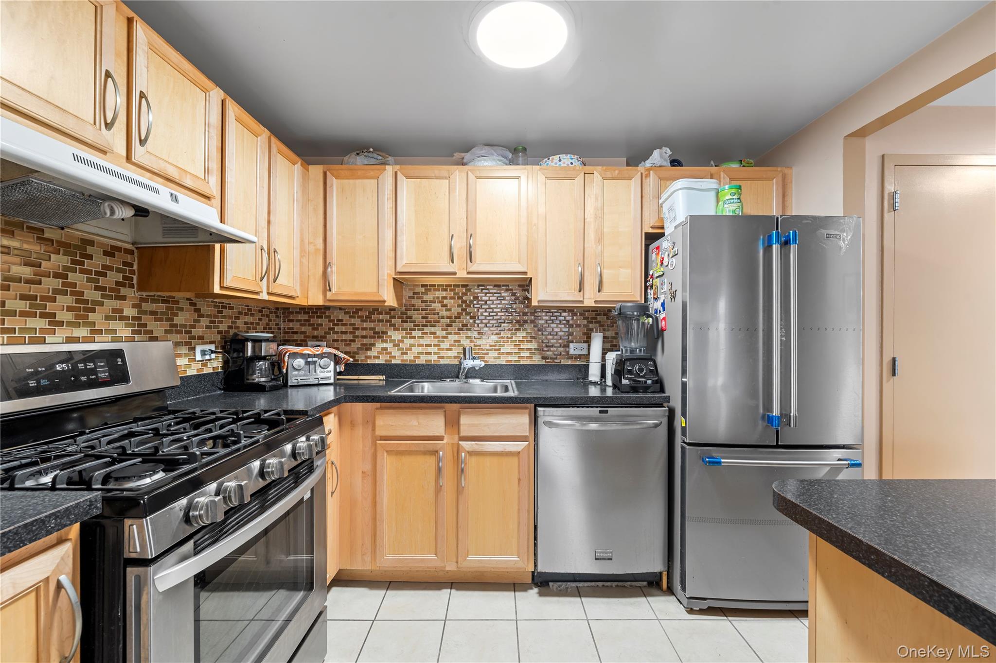 3044 3rd Avenue, Unit 6D Bronx, NY 10451 - Photo 6 of 19 a kitchen with stainless steel appliances granite countertop a sink stove and refrigerator