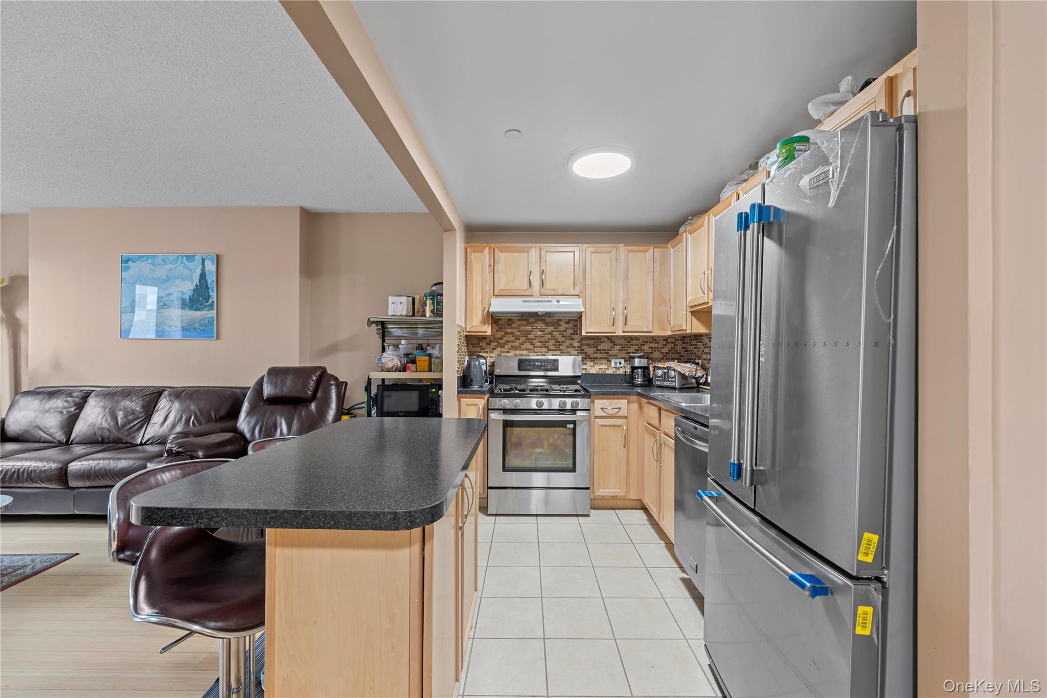 3044 3rd Avenue, Unit 6D Bronx, NY 10451 - Photo 19 of 19 a kitchen with stainless steel appliances granite countertop a refrigerator a stove a sink dishwasher and white cabinets with wooden floor