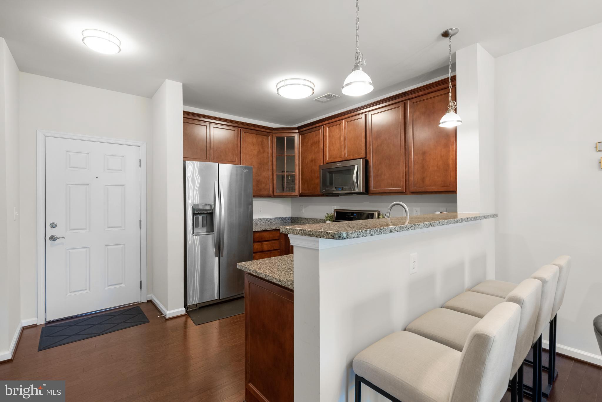 3835 Doc Berlin Drive, Unit 44 Silver Spring, MD 20906 - Photo 12 of 28 a kitchen with kitchen island a counter top space cabinets and stainless steel appliances