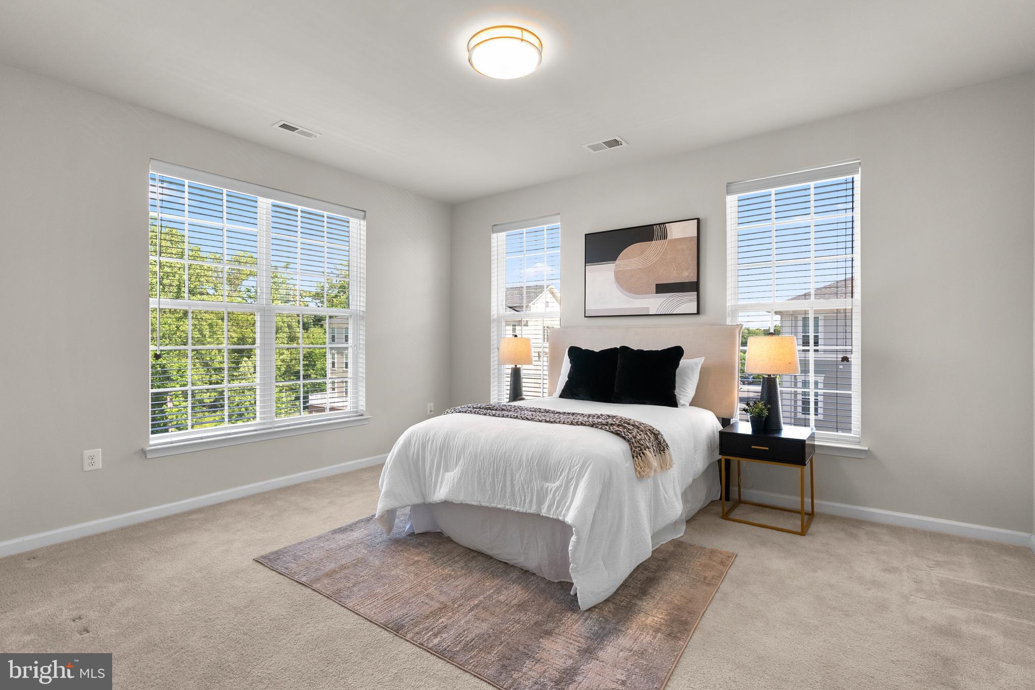 3835 Doc Berlin Drive, Unit 44 Silver Spring, MD 20906 - Photo 16 of 28 a spacious bedroom with a large bed and a window