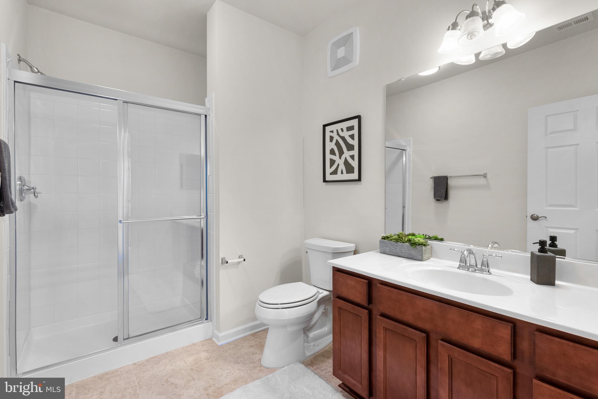 3835 Doc Berlin Drive, Unit 44 Silver Spring, MD 20906 - Photo 20 of 28 a spacious bathroom with a toilet a sink and a large mirror