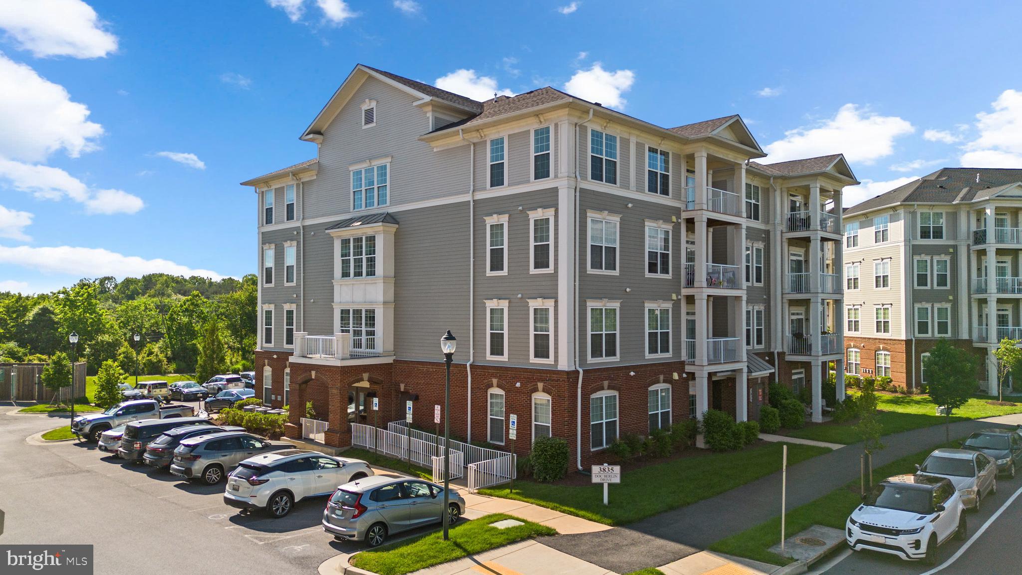 3835 Doc Berlin Drive, Unit 44 Silver Spring, MD 20906 - Photo 2 of 28 a large building with a yard in front of it