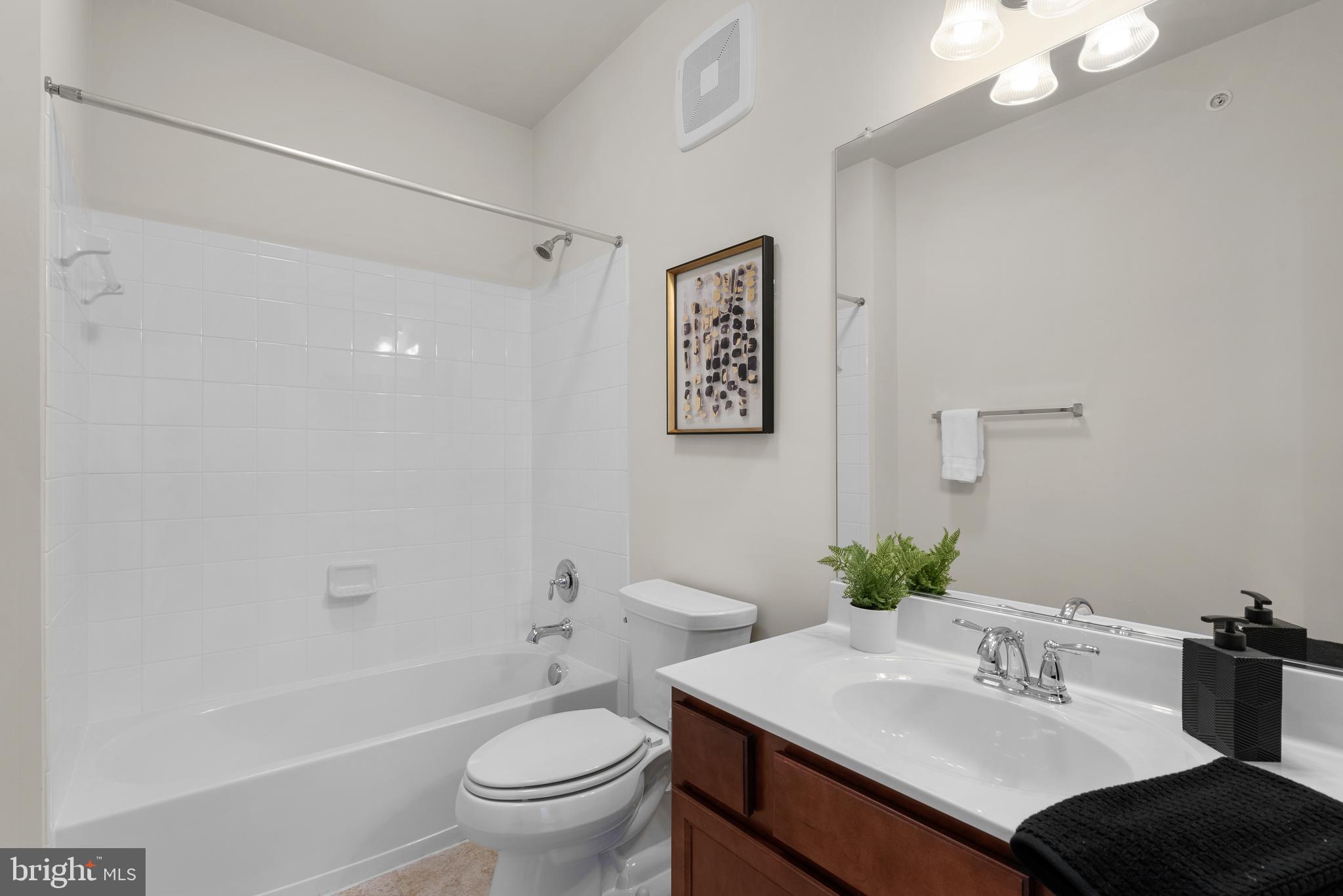 3835 Doc Berlin Drive, Unit 44 Silver Spring, MD 20906 - Photo 24 of 28 a bathroom with a sink vanity mirror and toilet