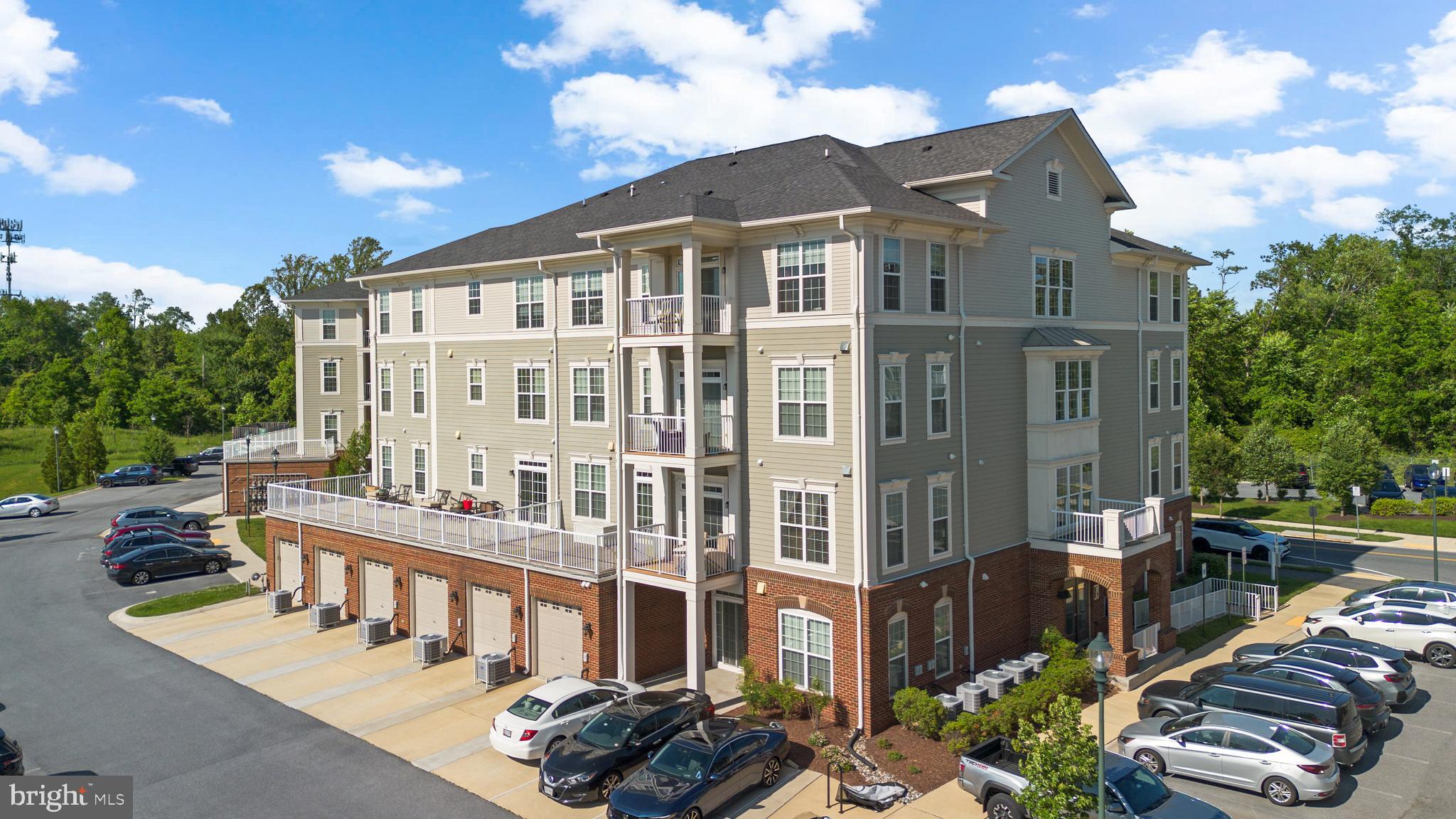 3835 Doc Berlin Drive, Unit 44 Silver Spring, MD 20906 - Photo 27 of 28 a view of a building with a yard and sitting area