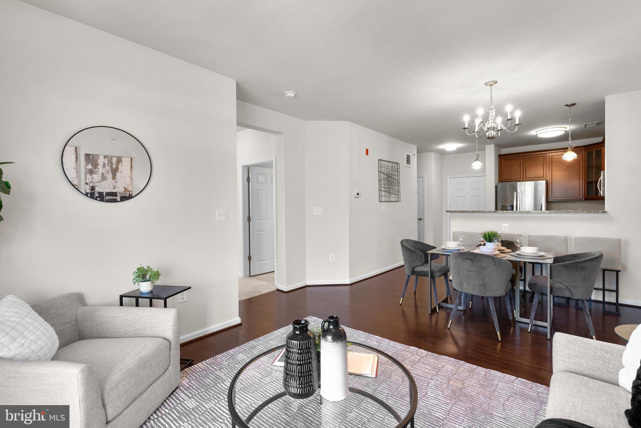3835 Doc Berlin Drive, Unit 44 Silver Spring, MD 20906 - Photo 7 of 28 a living room with furniture a dining table and a clock