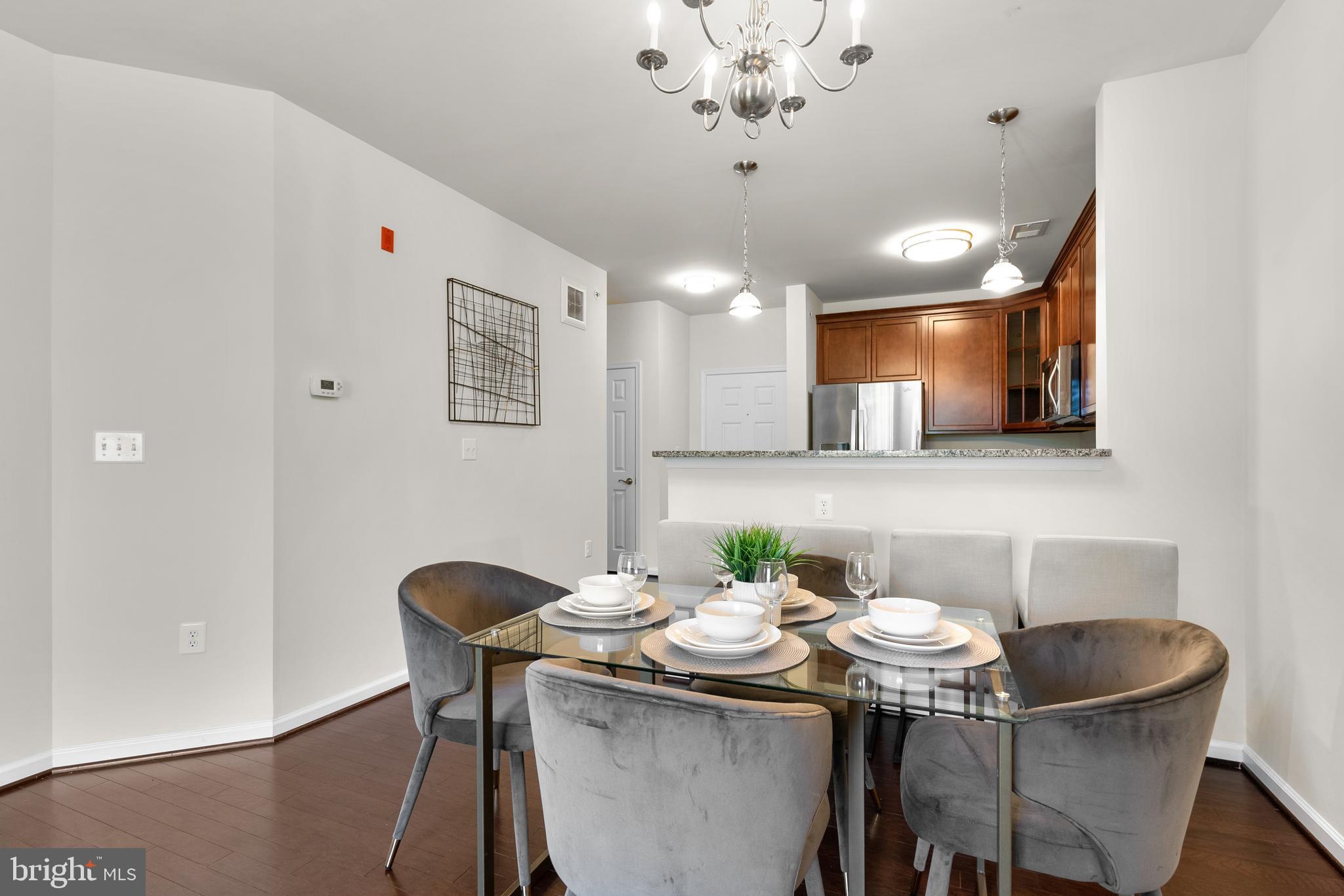 3835 Doc Berlin Drive, Unit 44 Silver Spring, MD 20906 - Photo 9 of 28 a view of a dining room with furniture and wooden floor
