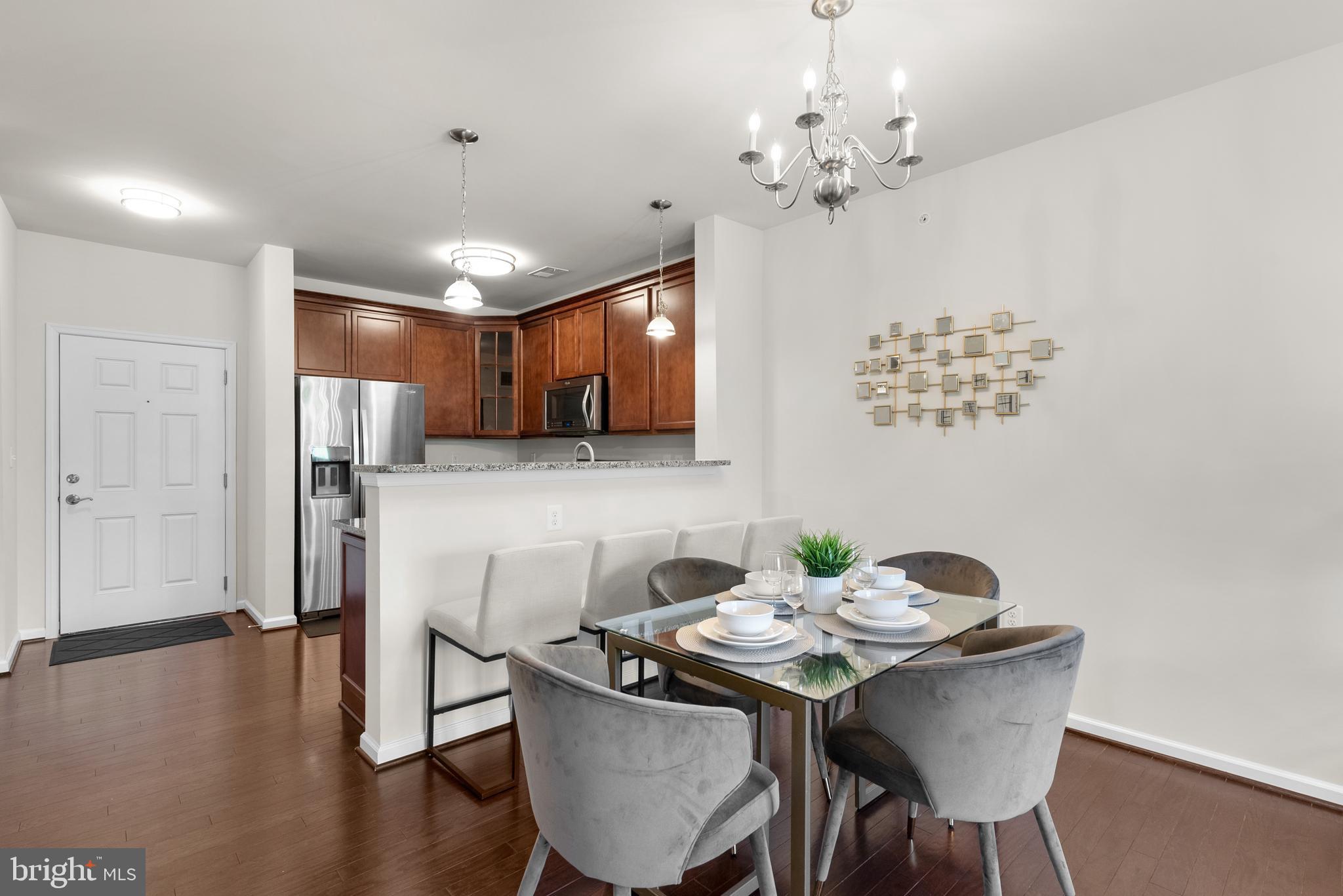 3835 Doc Berlin Drive, Unit 44 Silver Spring, MD 20906 - Photo 10 of 28 a view of a dining room with furniture wooden floor and chandelier