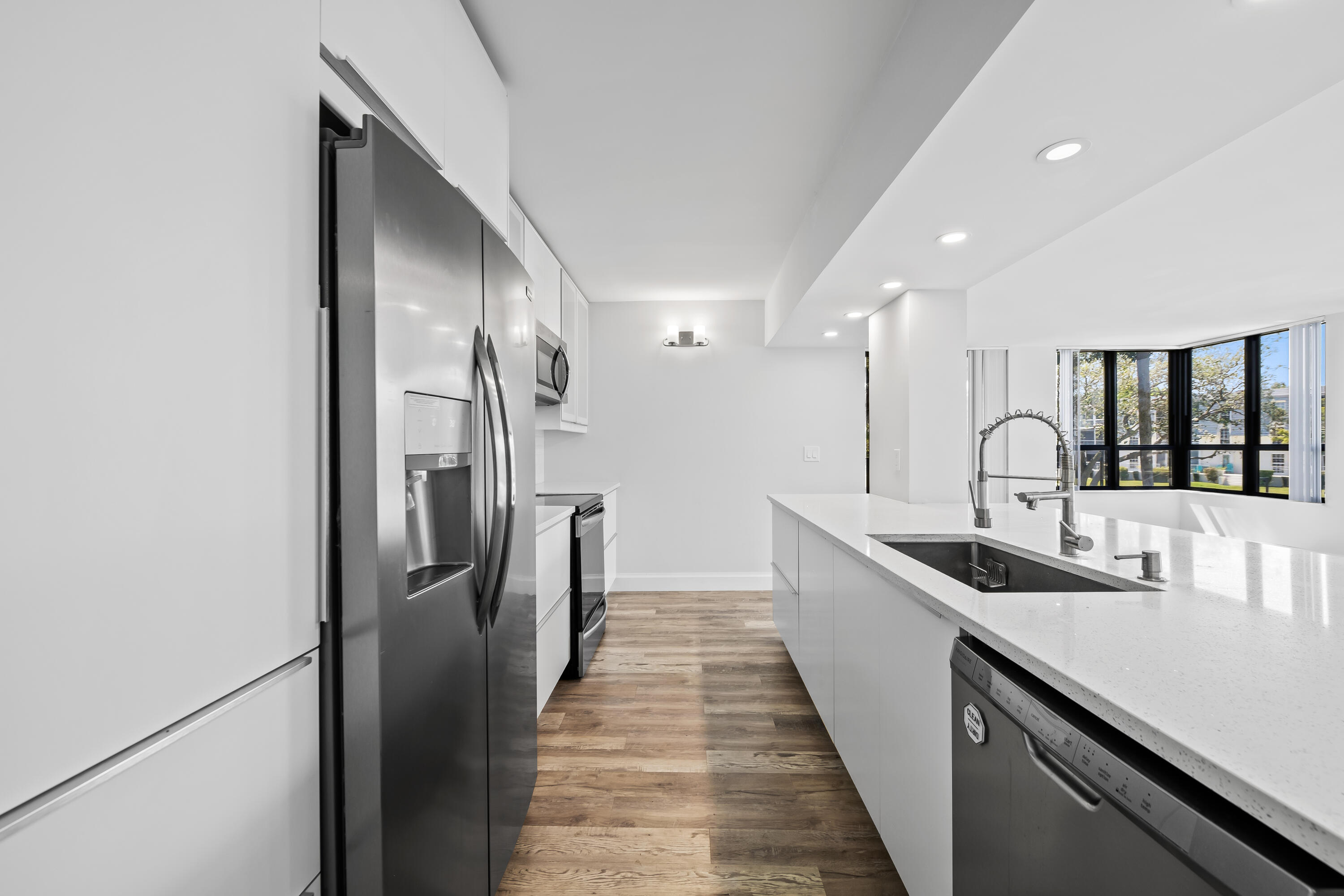 799 Jeffery Street, Unit 202 Boca Raton, FL 33487 - Photo 11 of 39 a kitchen with stainless steel appliances granite countertop a sink and refrigerator