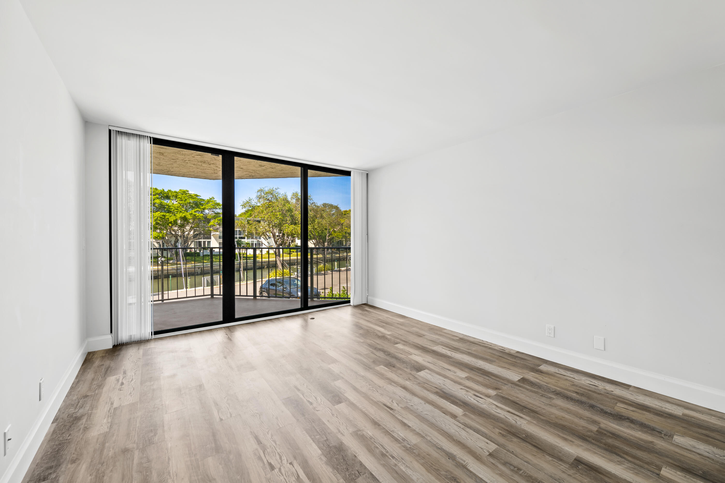 799 Jeffery Street, Unit 202 Boca Raton, FL 33487 - Photo 14 of 39 a view of an empty room with wooden floor and a window