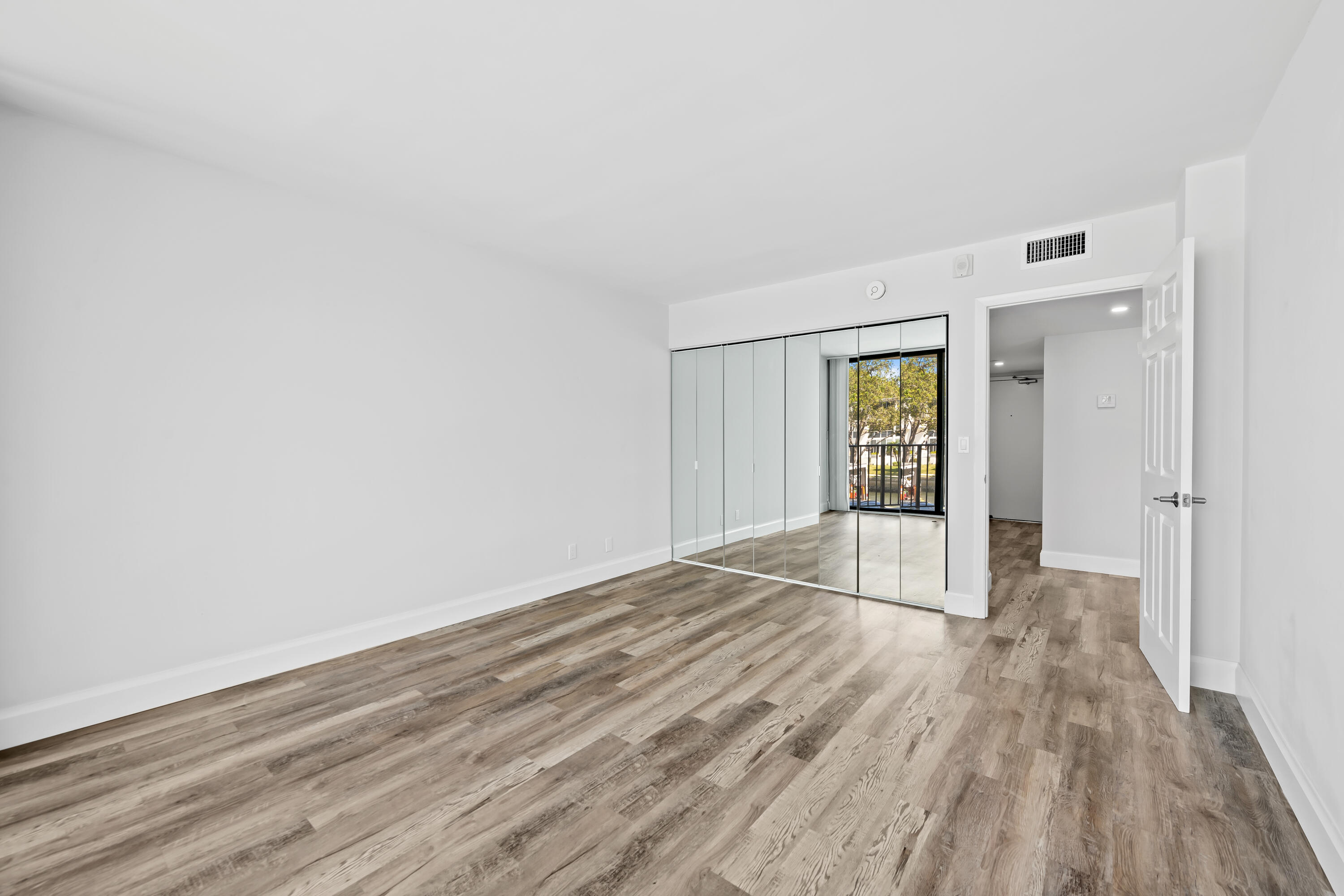 799 Jeffery Street, Unit 202 Boca Raton, FL 33487 - Photo 15 of 39 a view of an empty room with wooden floor and a window