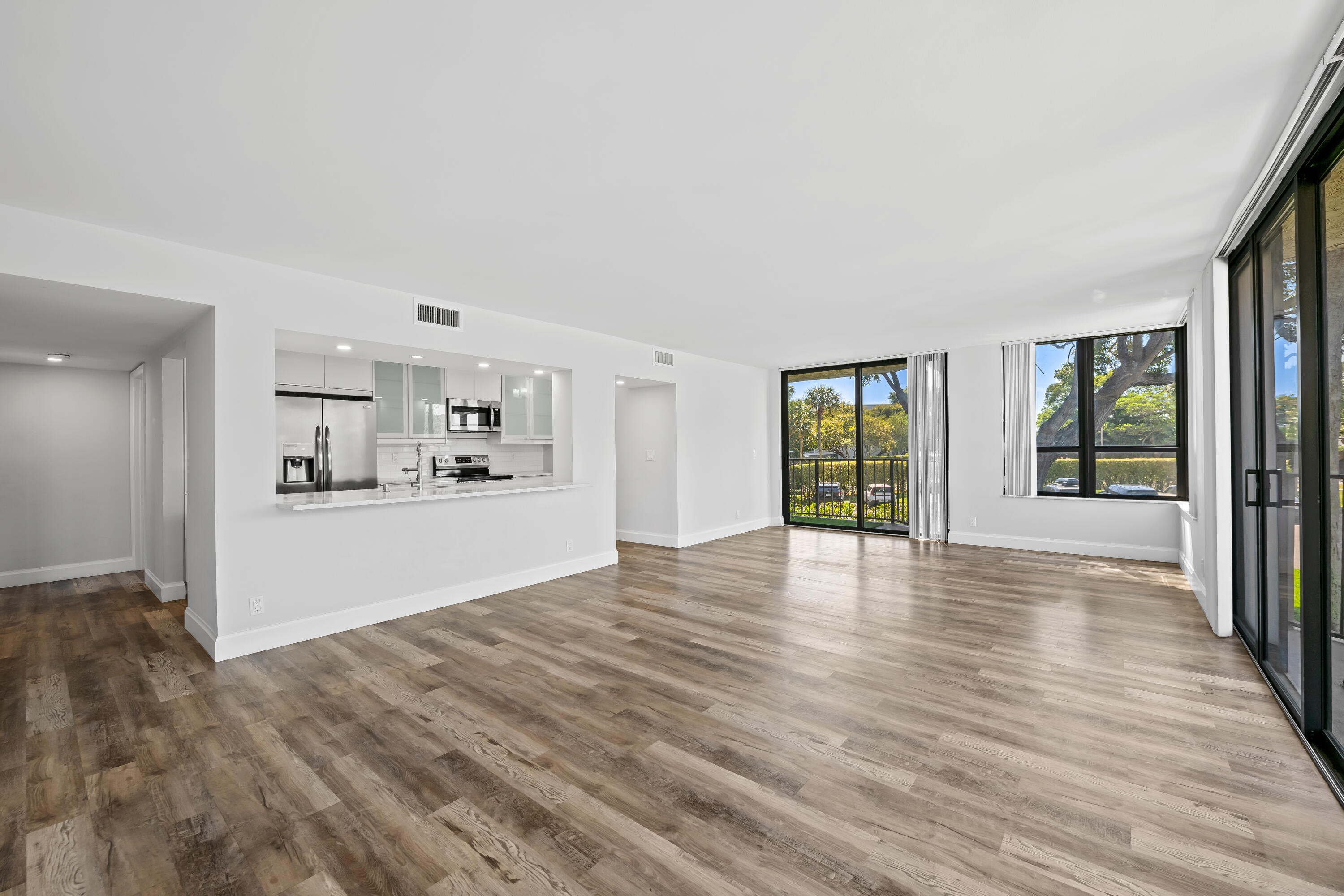 799 Jeffery Street, Unit 202 Boca Raton, FL 33487 - Photo 2 of 39 a view of an empty room with wooden floor and a window