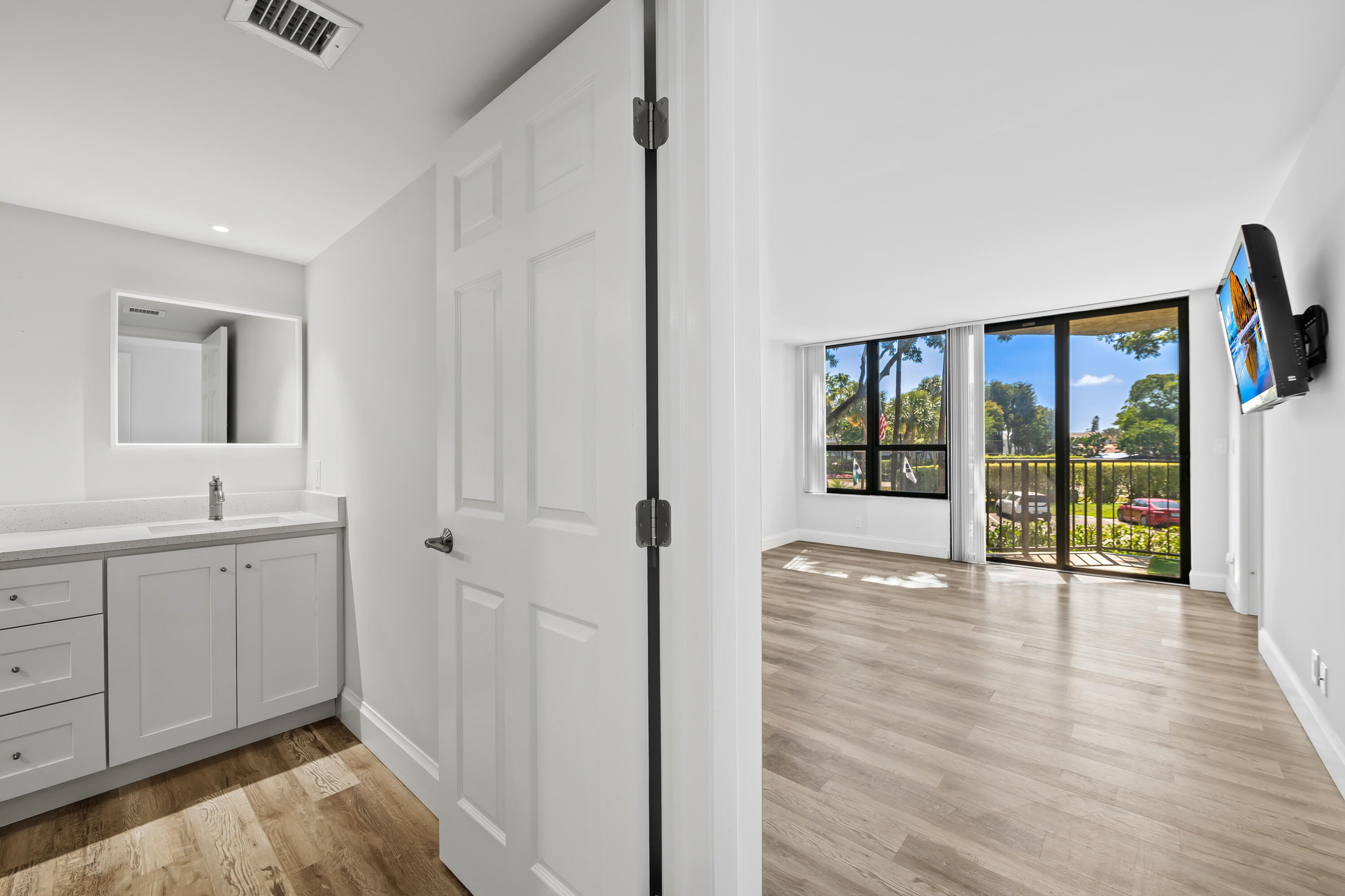 799 Jeffery Street, Unit 202 Boca Raton, FL 33487 - Photo 25 of 39 a view of an entryway with wooden floor and door