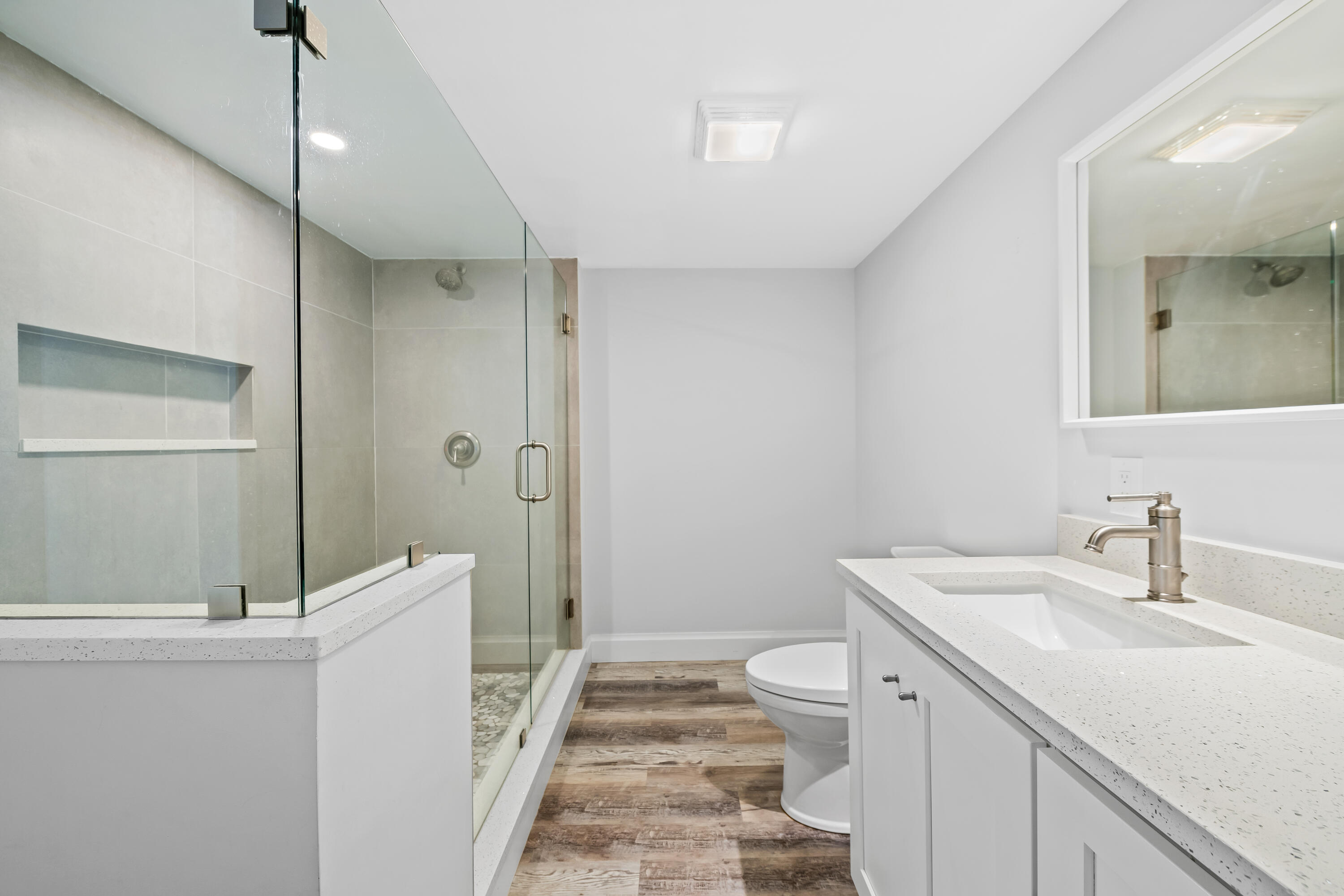 799 Jeffery Street, Unit 202 Boca Raton, FL 33487 - Photo 27 of 39 a bathroom with a double vanity sink toilet and shower