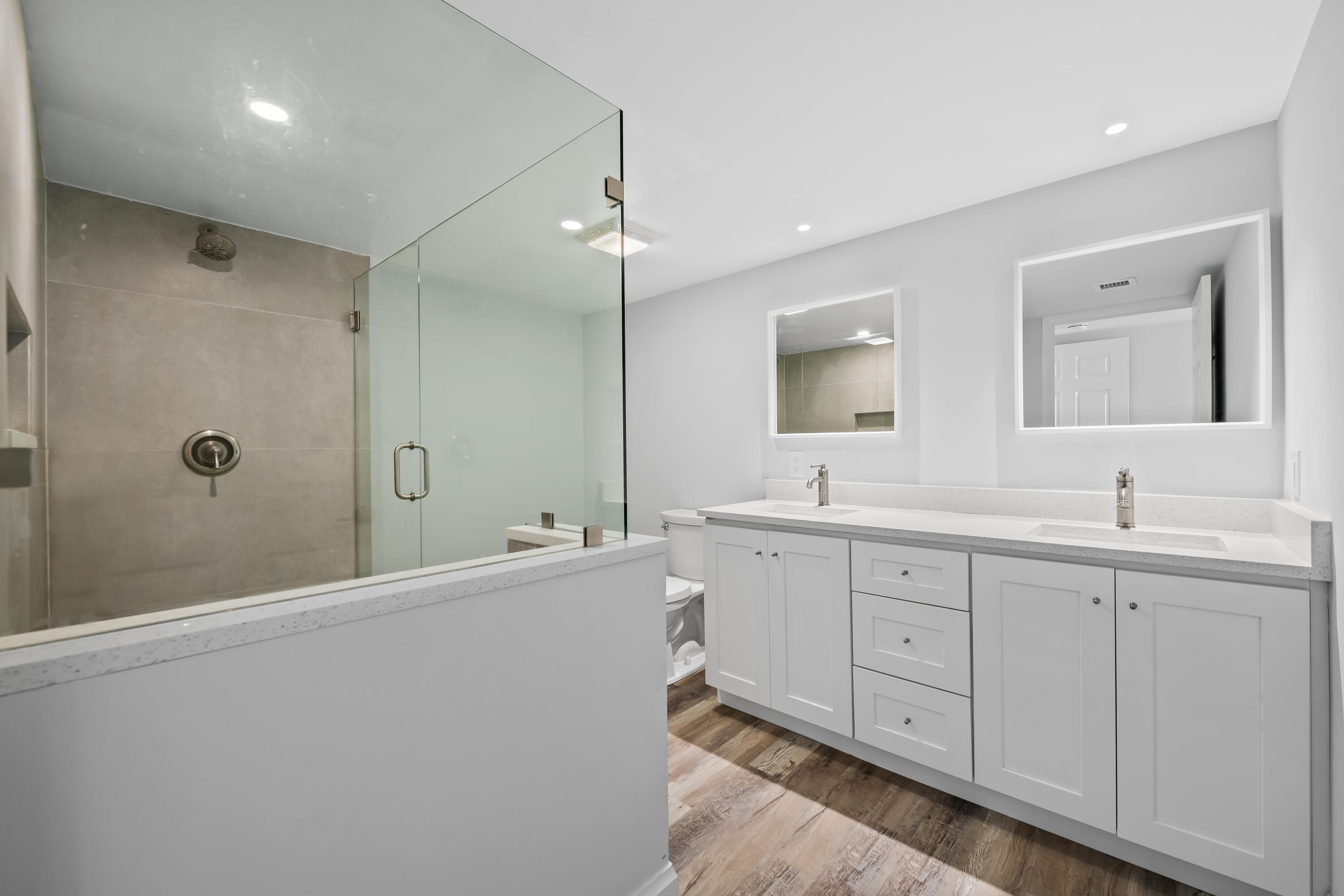 799 Jeffery Street, Unit 202 Boca Raton, FL 33487 - Photo 28 of 39 a spacious bathroom with double vanity a mirror and a shower