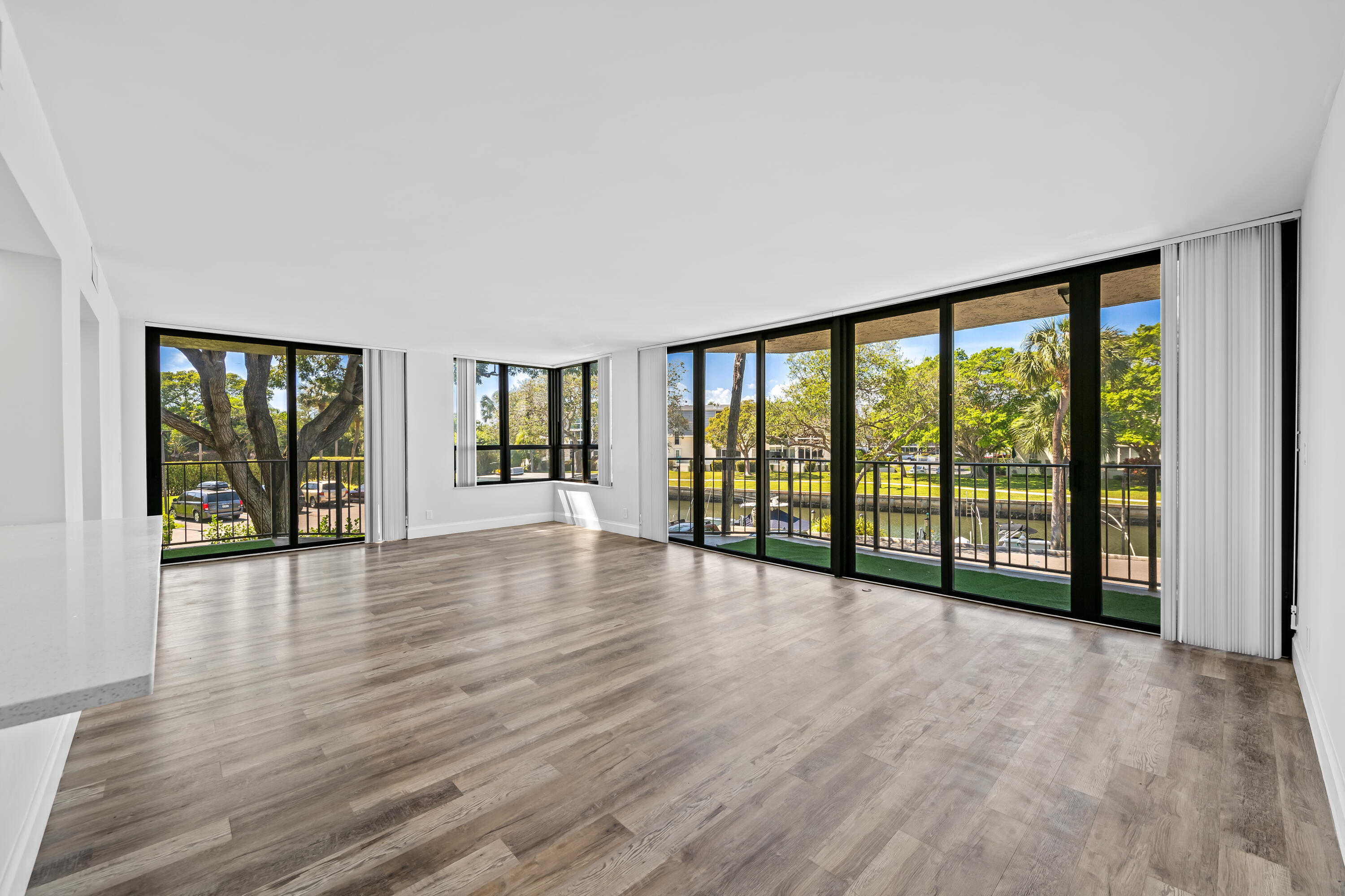 799 Jeffery Street, Unit 202 Boca Raton, FL 33487 - Photo 3 of 39 a view of an empty room with wooden floor and a window