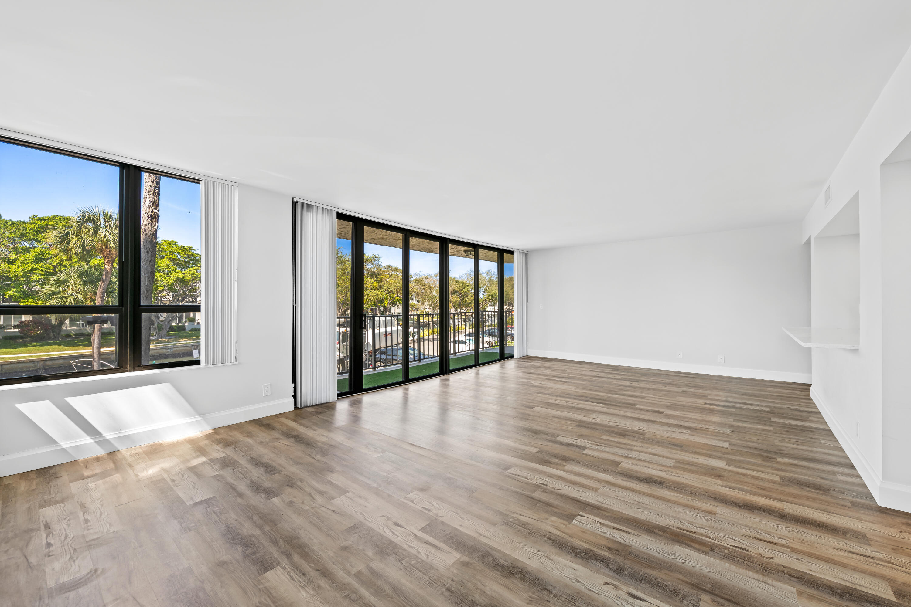 799 Jeffery Street, Unit 202 Boca Raton, FL 33487 - Photo 4 of 39 a view of an empty room with wooden floor and a window