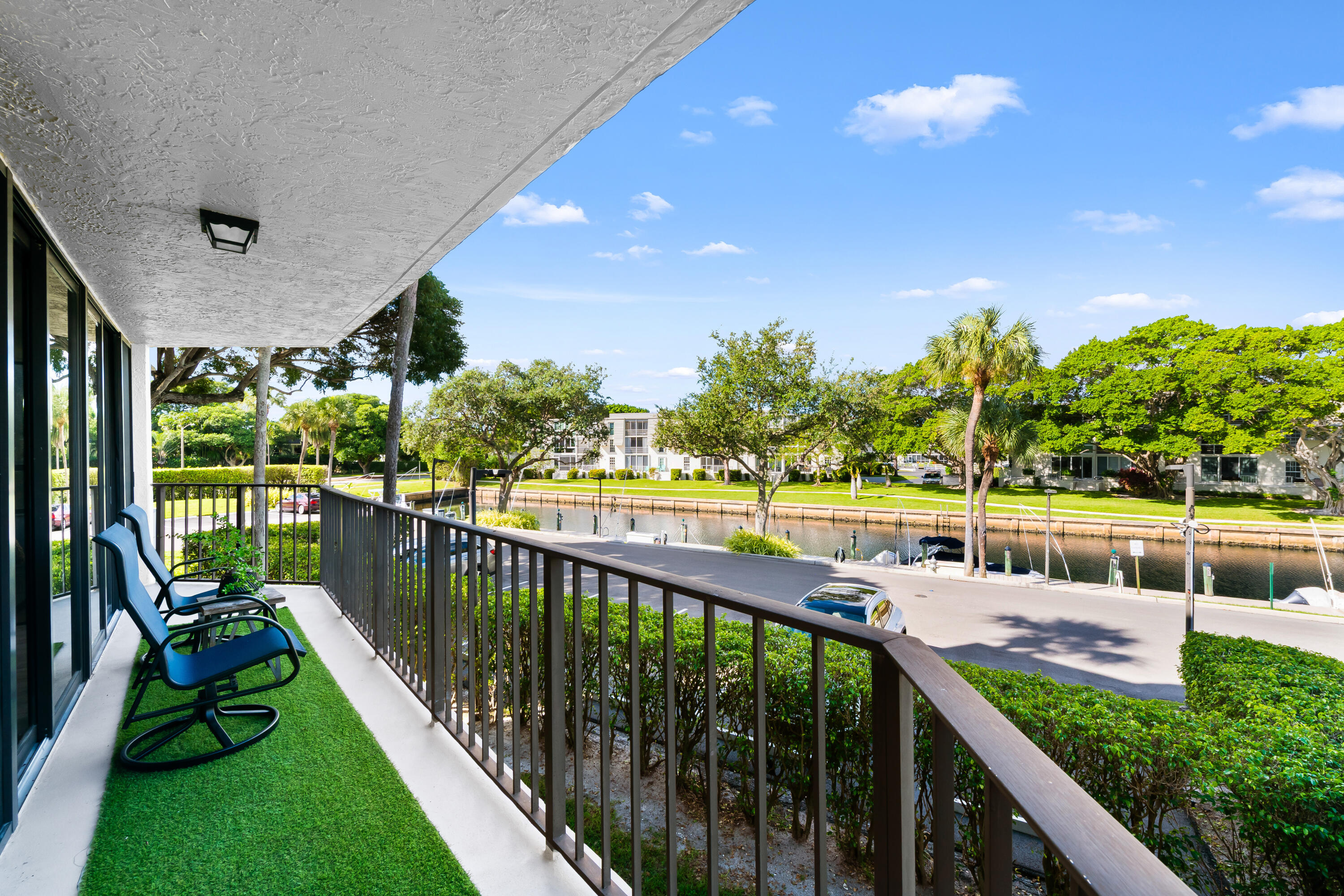 799 Jeffery Street, Unit 202 Boca Raton, FL 33487 - Photo 5 of 39 a view of a balcony with floor to ceiling windows and wooden fence