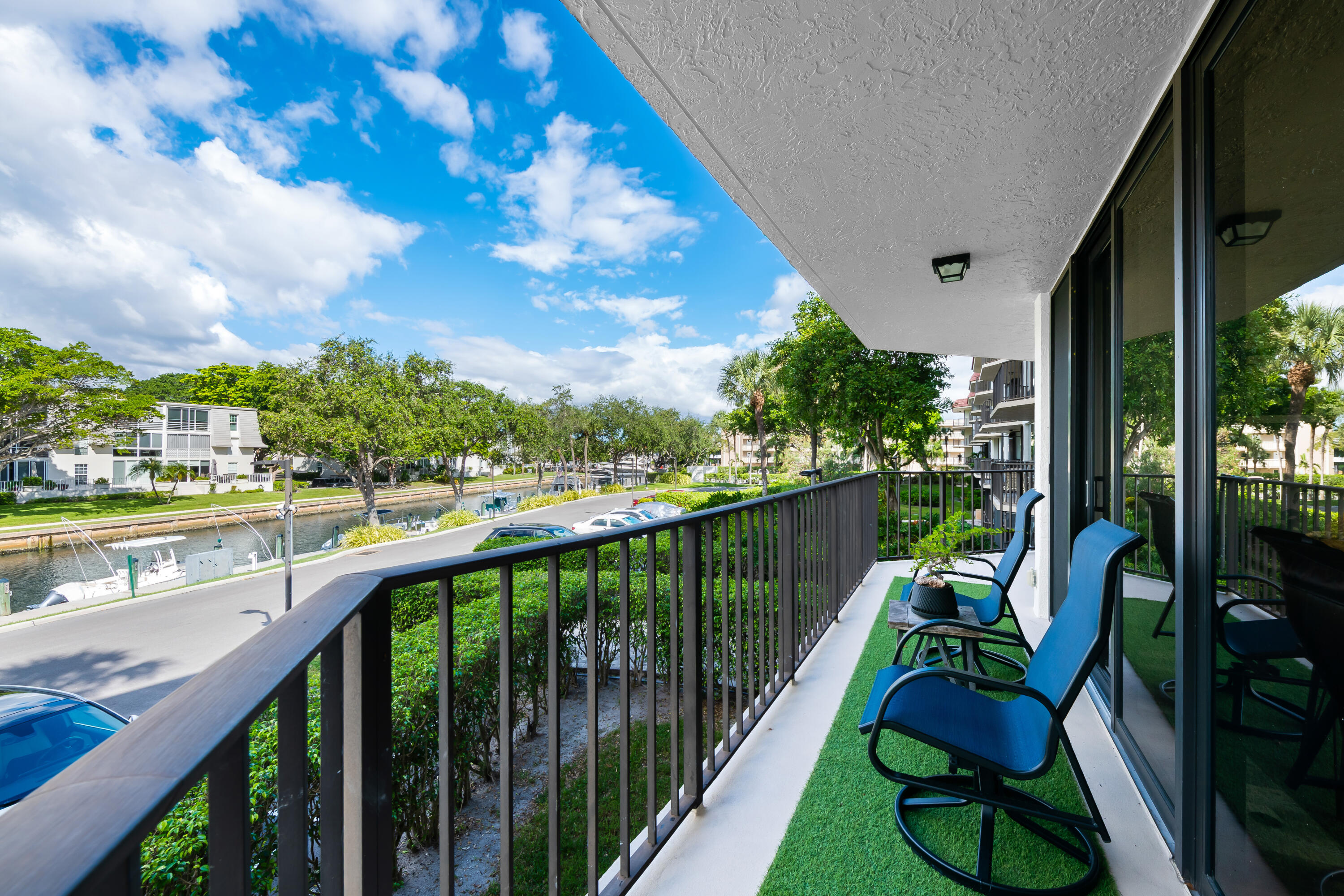 799 Jeffery Street, Unit 202 Boca Raton, FL 33487 - Photo 6 of 39 a balcony with wooden floor and outdoor seating