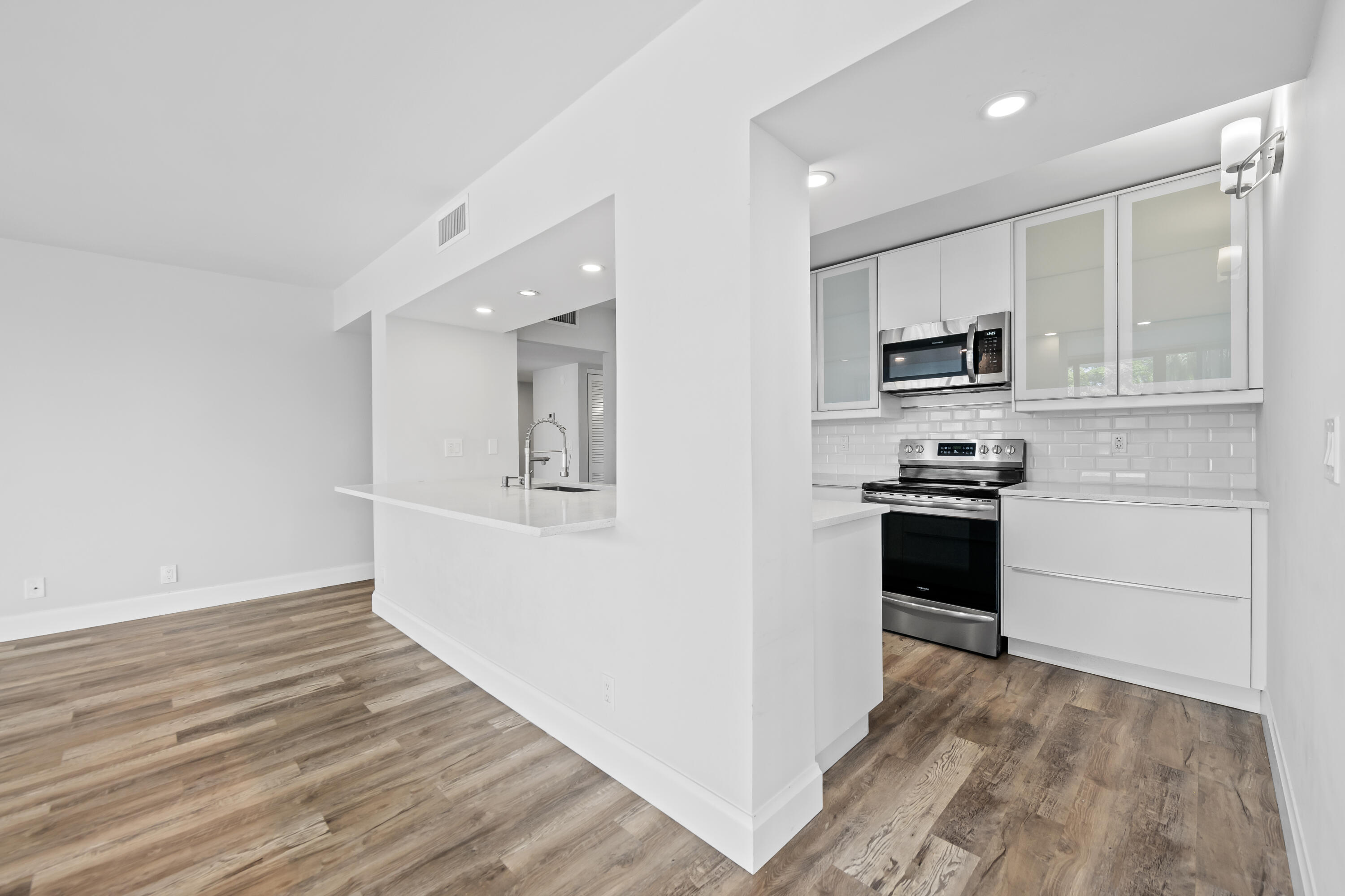 799 Jeffery Street, Unit 202 Boca Raton, FL 33487 - Photo 8 of 39 a kitchen with a refrigerator and a stove top oven