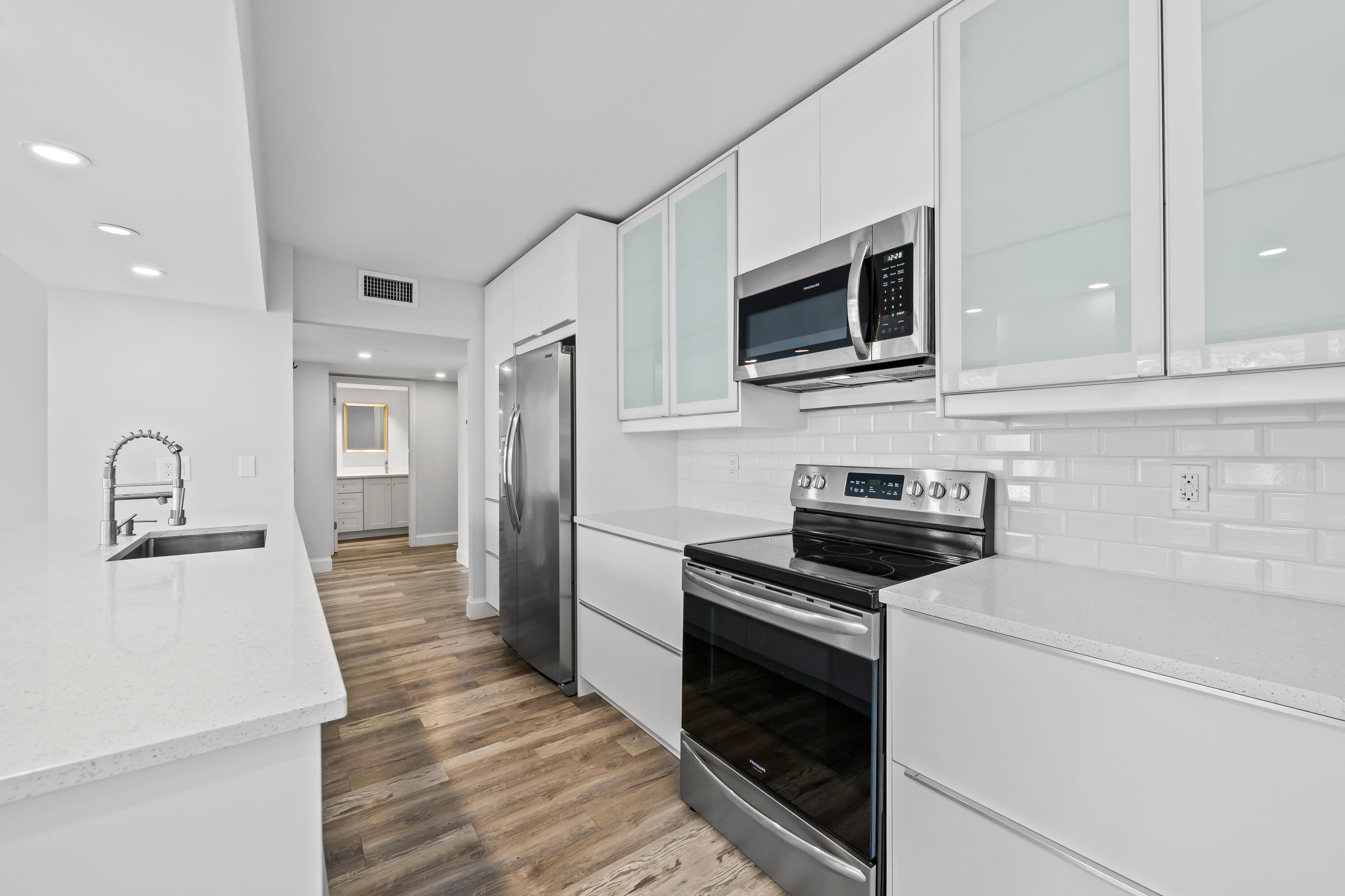 799 Jeffery Street, Unit 202 Boca Raton, FL 33487 - Photo 10 of 39 a kitchen with stainless steel appliances a stove microwave and refrigerator