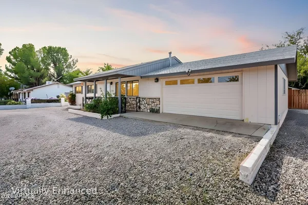 a view of a house with a yard and garage