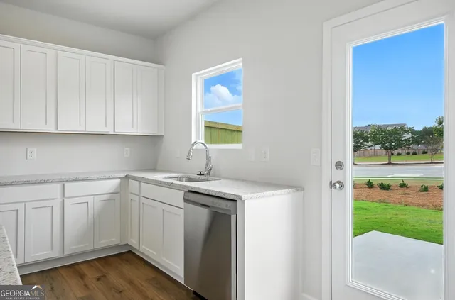 a kitchen with a sink cabinets and window