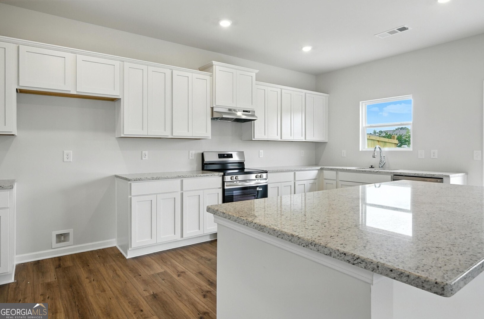 6 Umber Lane Newnan, GA 30263 - Photo 13 of 43 a kitchen with granite countertop a sink a stove and cabinets