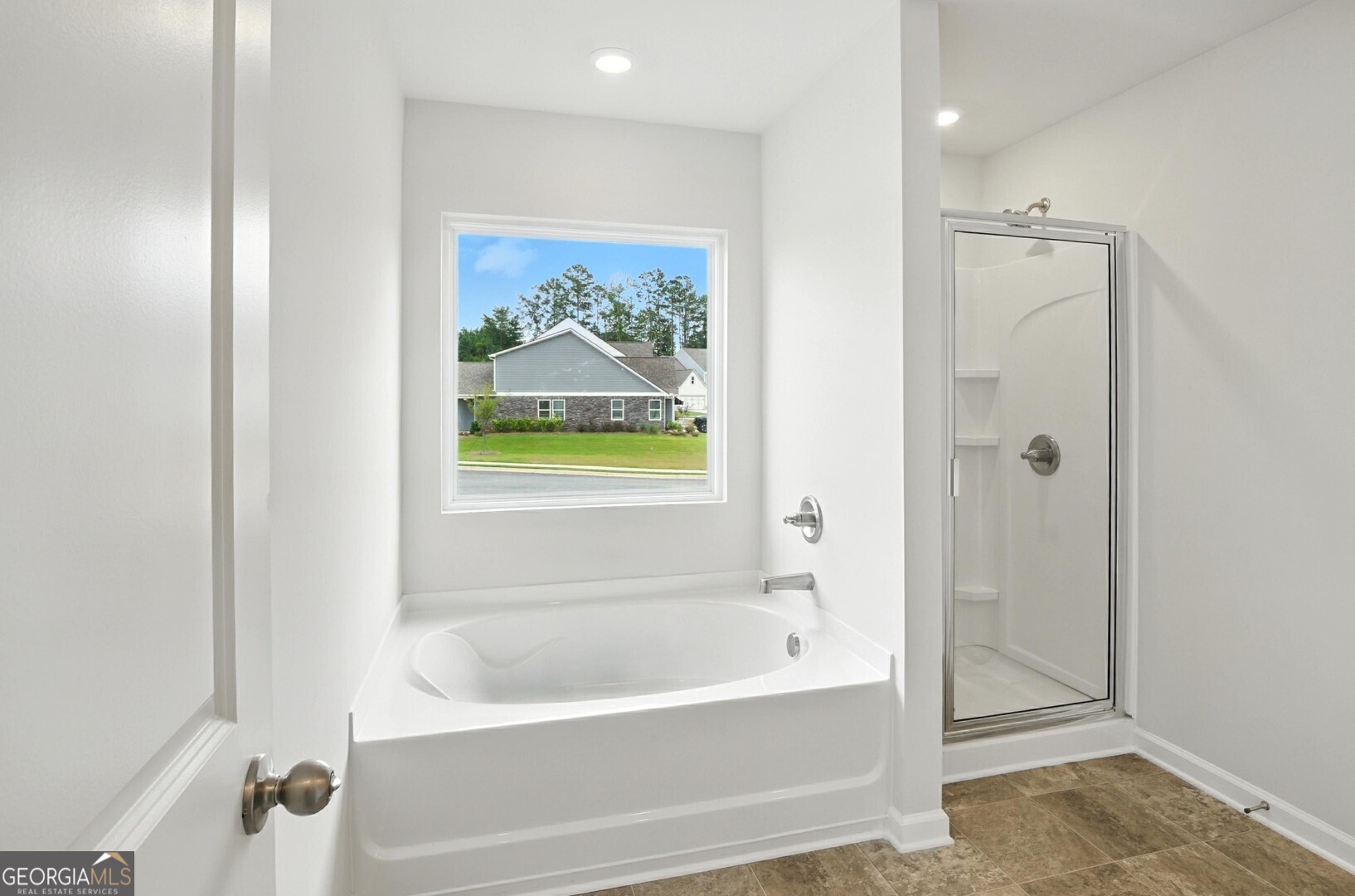 6 Umber Lane Newnan, GA 30263 - Photo 41 of 43 a bathroom with a bathtub and a shower