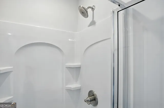 a bathroom with a shower and a toilet