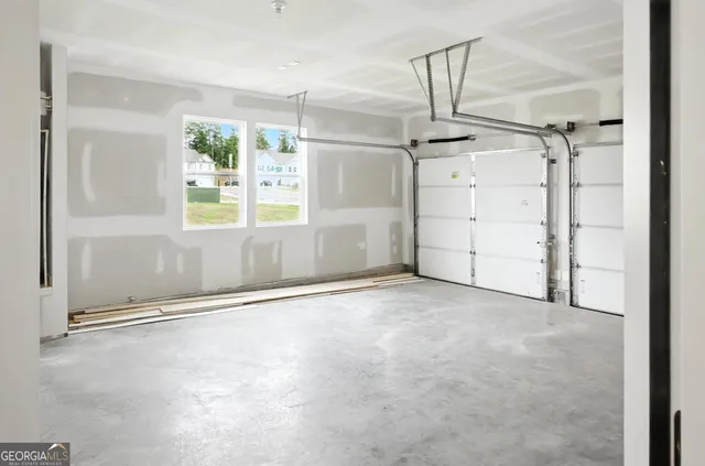 an empty room with windows and entryway