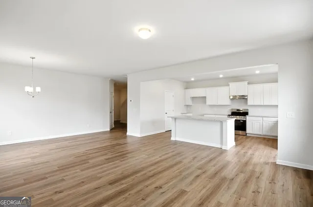 a view of kitchen with wooden floor and kitchen