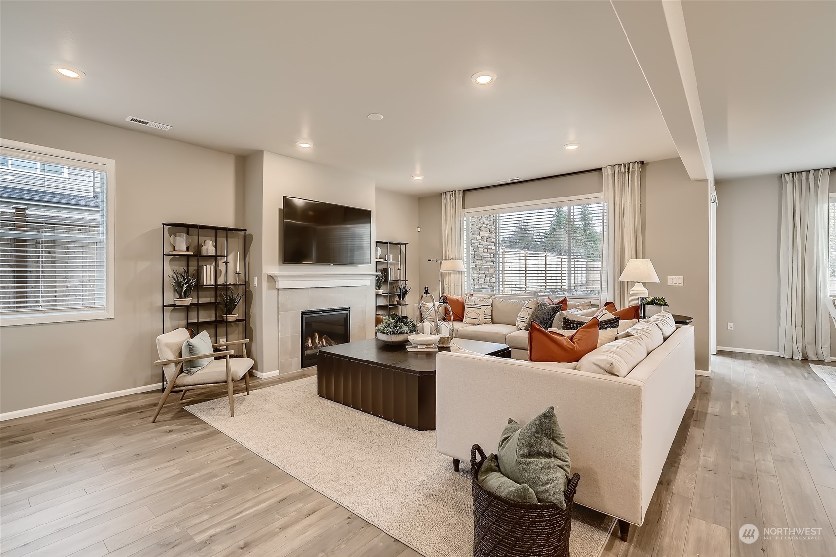 21017 42nd Avenue Southeast, Unit 114 Bothell, WA 98021 - Photo 13 of 22 a living room with fireplace furniture and a flat screen tv