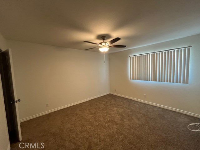 45313 Sunset Lane, Unit B6 #3 Palm Desert, CA 92260 - Photo 13 of 19 an empty room with windows and fan