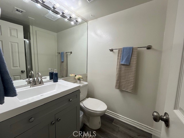 45313 Sunset Lane, Unit B6 #3 Palm Desert, CA 92260 - Photo 15 of 19 a bathroom with a toilet a sink and mirror