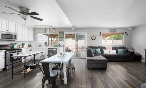 a view of a dining room with furniture and wooden floor
