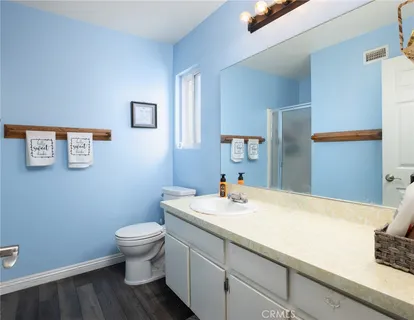 a bathroom with a sink toilet and a mirror