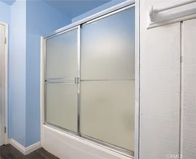 a bathroom with a glass shower door