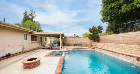 a view of a patio with table and chairs potted plants with wooden floor