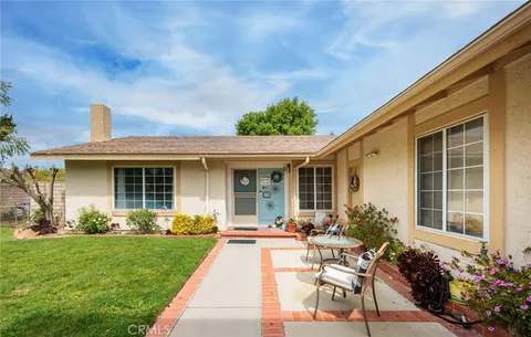 a view of a house with backyard sitting area and garden