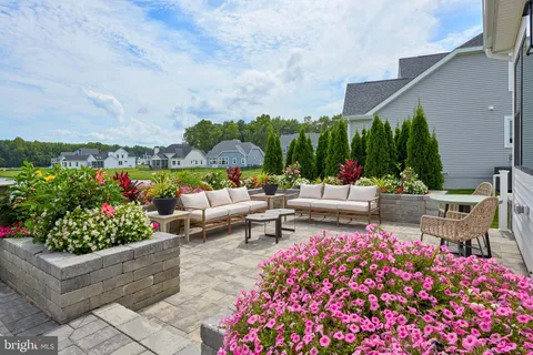 a view of a patio with table and chairs potted plants