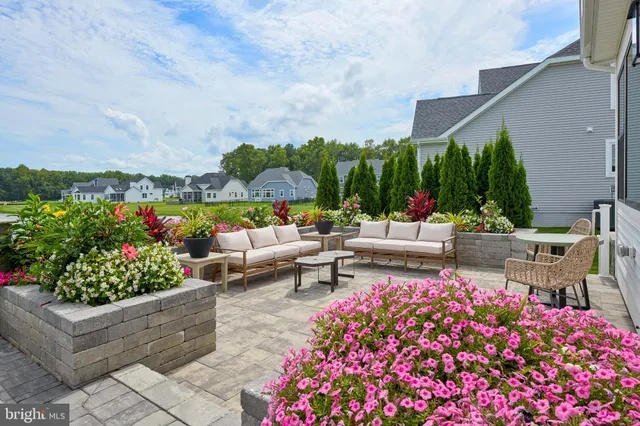 a view of a patio with table and chairs potted plants