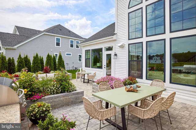 a backyard of a house with table and chairs