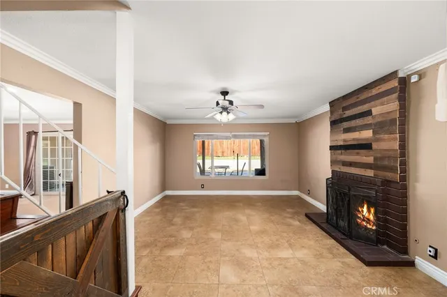 a view of an empty room with a fireplace and a window