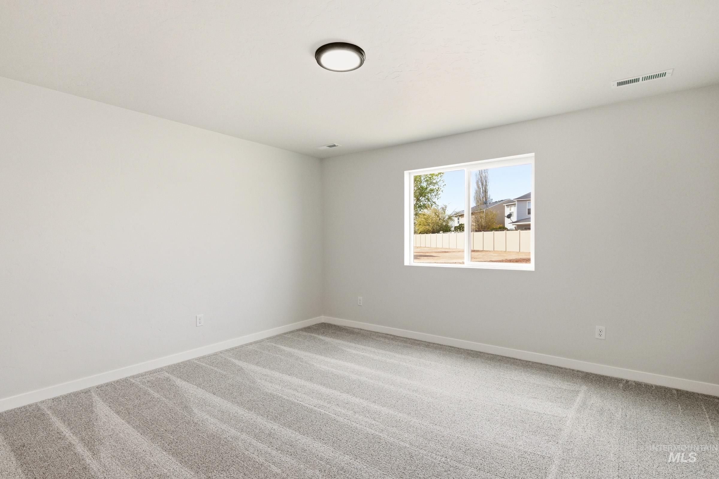 13735 Inman Court Caldwell, ID 83607 - Photo 15 of 20 Spare room with light carpet and baseboards