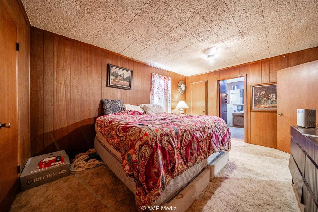 735 Northwest Ave F Hamlin, TX 79520 - Photo 13 of 18 a bed sitting in a spacious bedroom next to a window