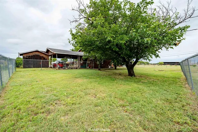 a view of a house with yard and sitting area